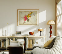 Perseus holding sword and Medusa head print in an oak frame above a mid-century book console with a vintage radio