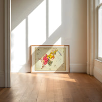 Perseus holding sword and Medusa head print in an oak frame on a sunlit wood floor beneath tall window light