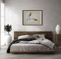 Pisces constellation with two fish print in a dark wood frame above a rattan bed on a plaster wall