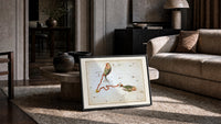 Pisces constellation with two fish print in a slim black frame leaning on a travertine coffee table