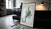 Scorpio zodiac constellation scorpion print in a slim black frame leaning on a dark sofa in a concrete print studio