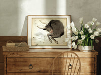 Taurus bull constellation chart print in an oak frame on a farmhouse dresser beside white tulips