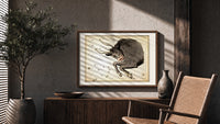 Taurus bull constellation chart print in a wood frame above a fluted sideboard beside an olive tree