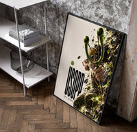Usopp aiming slingshot in action poster in a black frame leaning beside a shelf in a raw-plaster loft
