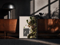 Black-framed Usopp aiming slingshot in action print on a moody console with designer coffee-table books