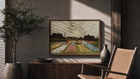 Flower fields with farmhouses print in a wood frame above a fluted sideboard beside an olive tree