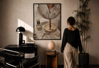 Vanity Mirror with Perfume and Jewelry print in a black frame on a sunlit wall with a viewer