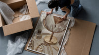 Vanity Mirror with Perfume and Jewelry framed print being unpacked from protective bubble wrap and a box