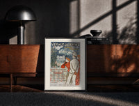 Black-framed elegant couple viewing spa resort print on a moody console with designer coffee-table books