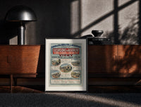 Black-framed French railway travel timetable poster print on a moody console with designer coffee-table books