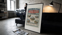 French railway travel timetable poster print in a slim black frame leaning on a dark sofa in a concrete print studio