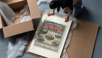 French railway travel timetable poster framed print being unpacked from protective bubble wrap and a box