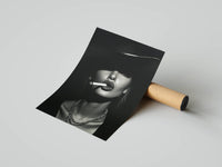 Rolled monochrome portrait print draped over a kraft tube showing a hat-wearing model in vintage style
