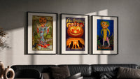Vintage Halloween pumpkin-headed figures triptych in three black frames on a grey wall above a leather sofa