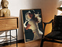 Brass-framed vintage tennis serve print leaning in a warm styled corner by a sculpture