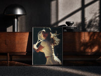 Black-framed vintage tennis serve print on a moody console with designer coffee-table books
