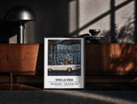 Black-framed White convertible car with elegant couples print on a moody console with designer coffee-table books