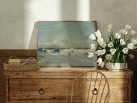 Ocean waves breaking on shore print in an oak frame on a farmhouse dresser beside white tulips
