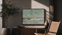 Ocean waves breaking on shore print in a wood frame above a fluted sideboard beside an olive tree