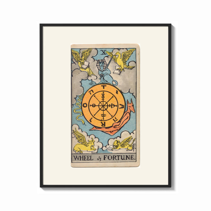 Framed Wheel of Fortune tarot card print shown as a bold statement piece on a clean gallery wall