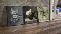 Floral still life triptych paintings three-piece set leaning on parquet beside a vintage loft door