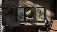 Floral still life triptych paintings triptych in three walnut frames above a sideboard in a warm room