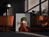 Black-framed White Flowers Over the Face print on the floor in front of a dark wooden console