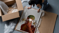White Flowers Over the Face framed print being unpacked from protective bubble wrap and a box