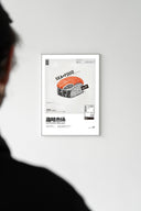 White-framed SEAxFOOD Market Original Salmon Sushi poster on white wall with silhouetted viewer in foreground