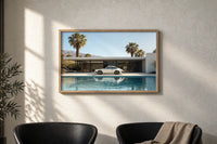 White 911 Desert Modern Pool House print in an oak frame on a sunlit wall above two leather armchairs