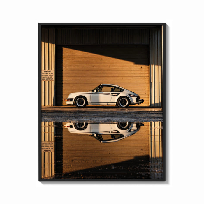 Framed White 911 Hangar Sunset Reflection print shown as a bold statement piece on a clean gallery wall