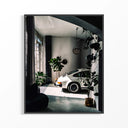 White Porsche 911 sports car displayed in modern industrial loft with concrete floors and pendant lighting
