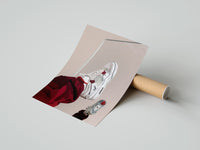 Gently curled White Sneakers with Burgundy Trousers print beside its protective shipping tube