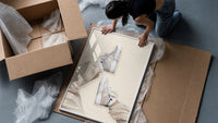 White Sneakers with Cream Trousers framed print being unpacked from protective bubble wrap and a box