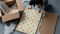 Vintage floral pattern with daisies framed print being unpacked from protective bubble wrap and a box