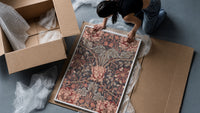 Ornate floral honeysuckle pattern framed print being unpacked from protective bubble wrap and a box