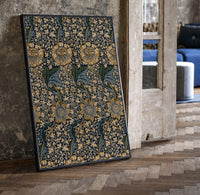 Ornate floral vine pattern print in a black frame leaning beside a vintage door on parquet
