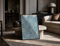 Floral marigold pattern with leaves print in a black frame leaning on a travertine table in a sunlit lounge
