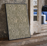 Floral marigold vine pattern print in a black frame leaning beside a vintage door on parquet