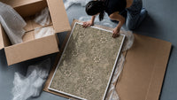 Floral marigold vine pattern framed print being unpacked from protective bubble wrap and a box