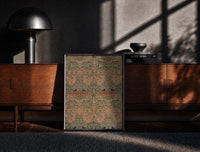 Black-framed Floral bird damask textile pattern print on a moody console with designer coffee-table books