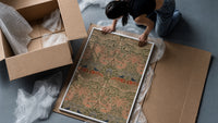 Floral bird damask textile pattern framed print being unpacked from protective bubble wrap and a box