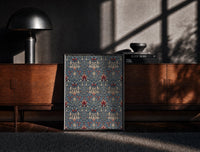 Black-framed Victorian floral damask pattern print on a moody console with designer coffee-table books