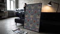 Victorian floral damask pattern print in a slim black frame leaning on a dark sofa in a concrete print studio