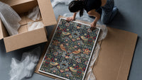 Birds and strawberries floral pattern framed print being unpacked from protective bubble wrap and a box
