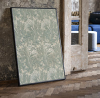 Ornate floral tulip leaf pattern print in a black frame leaning beside a vintage door on parquet