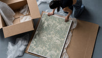 Ornate floral tulip leaf pattern framed print being unpacked from protective bubble wrap and a box