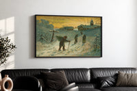 Winter Village Christmas Greetings print in a black frame above a black leather sofa on a white wall