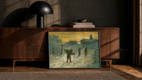 Winter Village Christmas Greetings print in a black frame leaning against a walnut sideboard