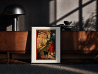 Black-framed Witch with broom peering through window print on a moody console with designer coffee-table books